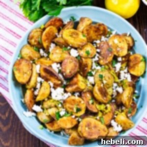 Greek Potatoes in a light blue bowl.