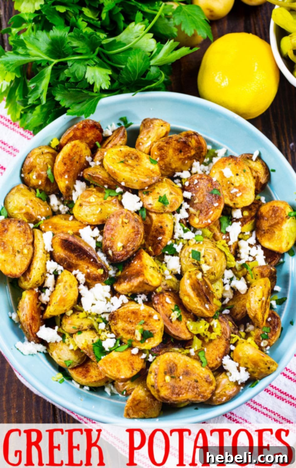 Classic Greek Lemon Potatoes 6 A stunning overhead shot of crispy roasted Greek Potatoes, garnished with vibrant lemon slices and crumbled feta, ready to impress at any meal.