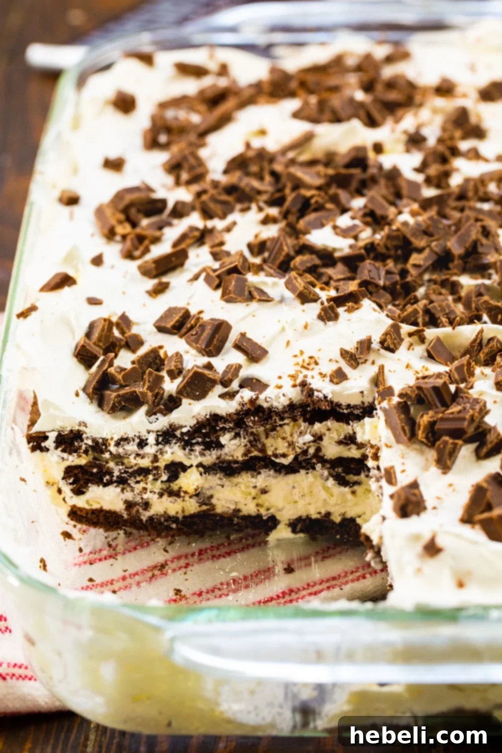 Finished White Chocolate Lasagna in a 9x13-inch baking dish with a slice removed, revealing the delightful layers.