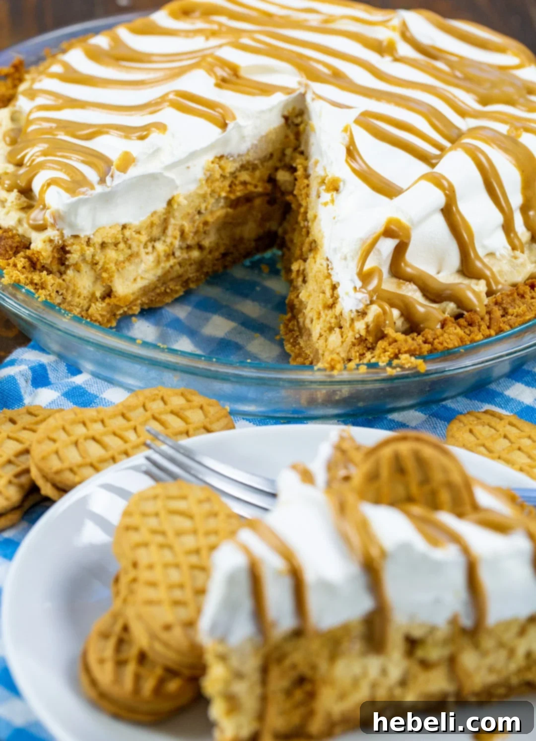 Peanut Butter Bliss Pie 3 A beautifully presented Nutter Butter Pie with a slice removed, revealing its rich, layered peanut butter filling and golden cookie crust.