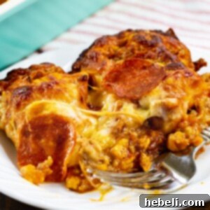 A delectable slice of Meat Lovers Bubble Up Pizza, perfectly browned and cheesy, resting on a white plate ready to be enjoyed.