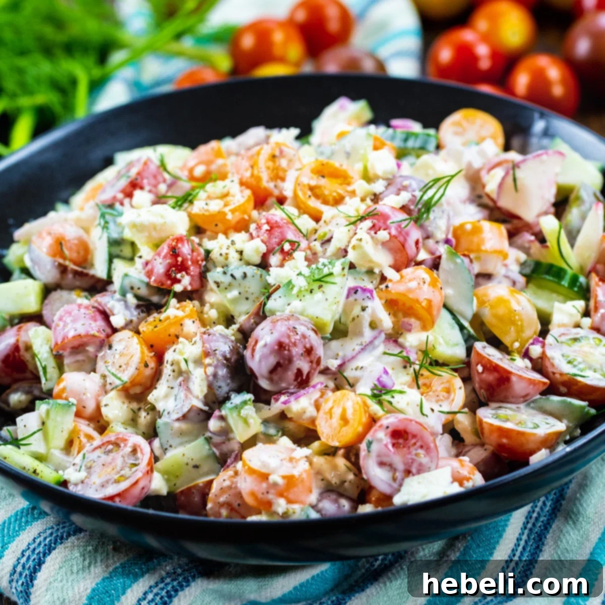 Creamy Tomato and Cucumber Chopped Salad in a sleek black bowl, garnished with fresh dill.