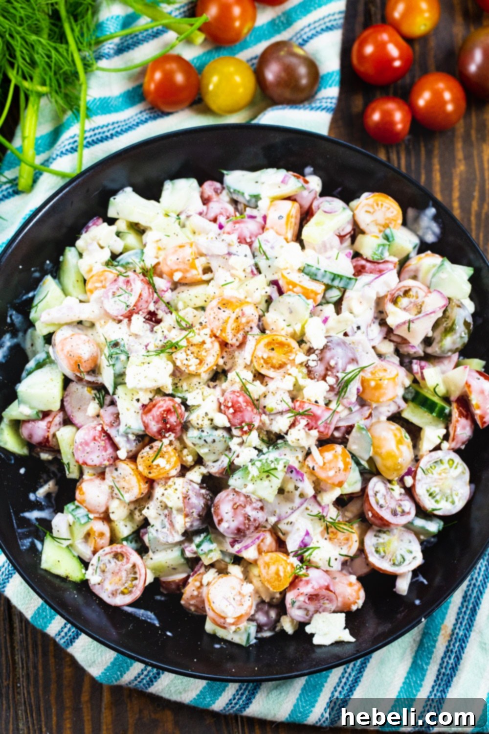 Vibrant Tomato and Cucumber Salad featuring an array of colorful cherry tomatoes artfully arranged around the bowl.