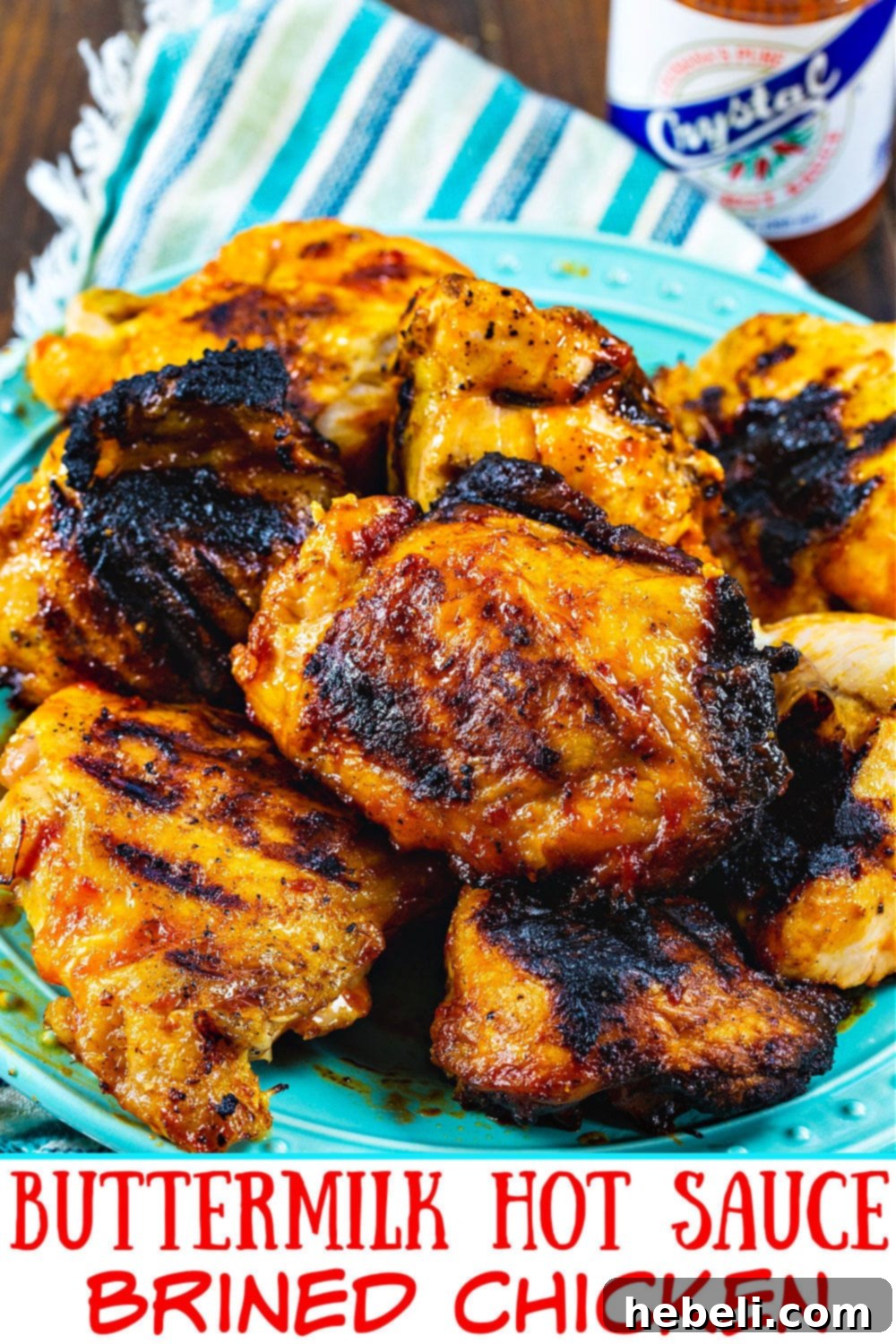Buttermilk Hot Sauce Brined Chicken on a plate, garnished with fresh herbs and a drizzle of sauce.