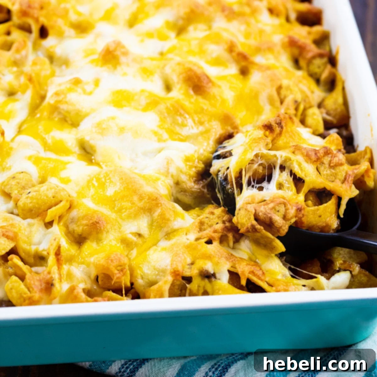 Sloppy Joe Frito Casserole in a 9x13-inch baking dish, fresh from the oven, showing golden Fritos and bubbly cheese.