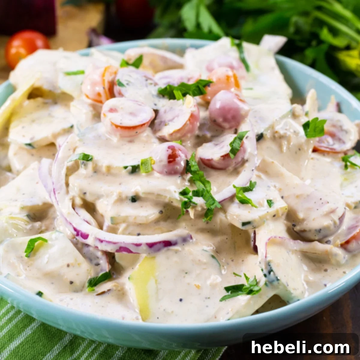 Tuscan Creamed Cucumber Salad 2 Creamy Italian Cucumber Salad in a blue bowl.