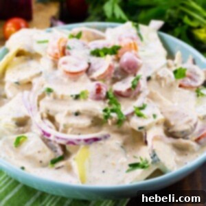 Tuscan Creamed Cucumber Salad 5 Creamy Italian Cucumber Salad in a blue bowl.