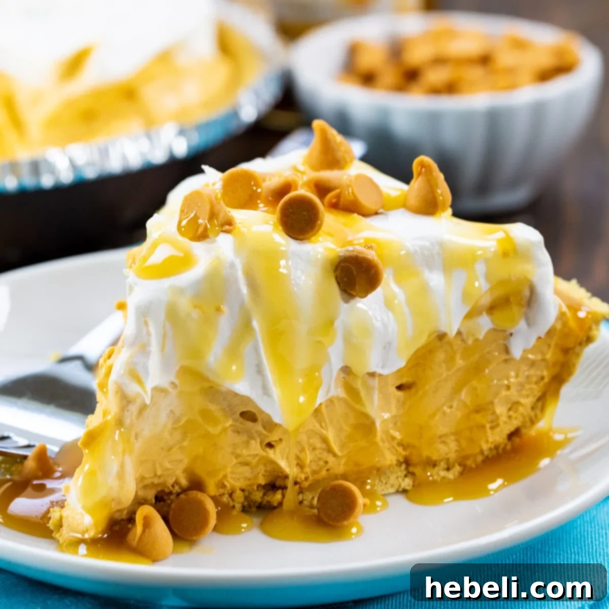 A perfectly sliced piece of No-Bake Butterscotch Pie on a plate, showcasing its creamy texture and a sprinkle of butterscotch chips.