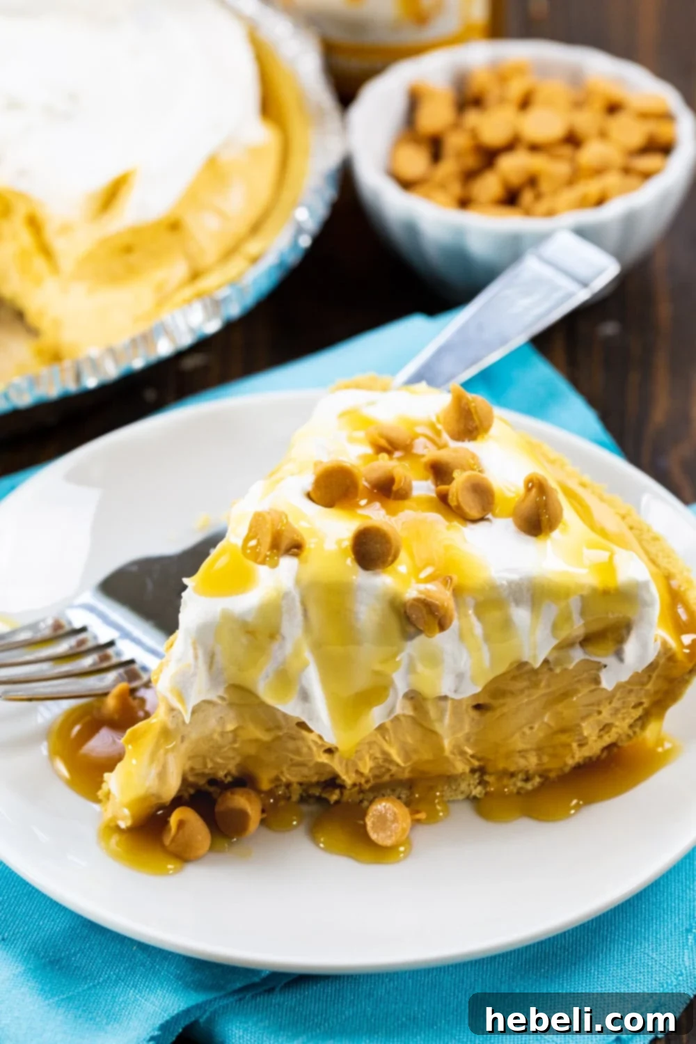 A whole No-Bake Butterscotch Pie with a slice removed, showing its perfect creamy layers and golden-brown crust.