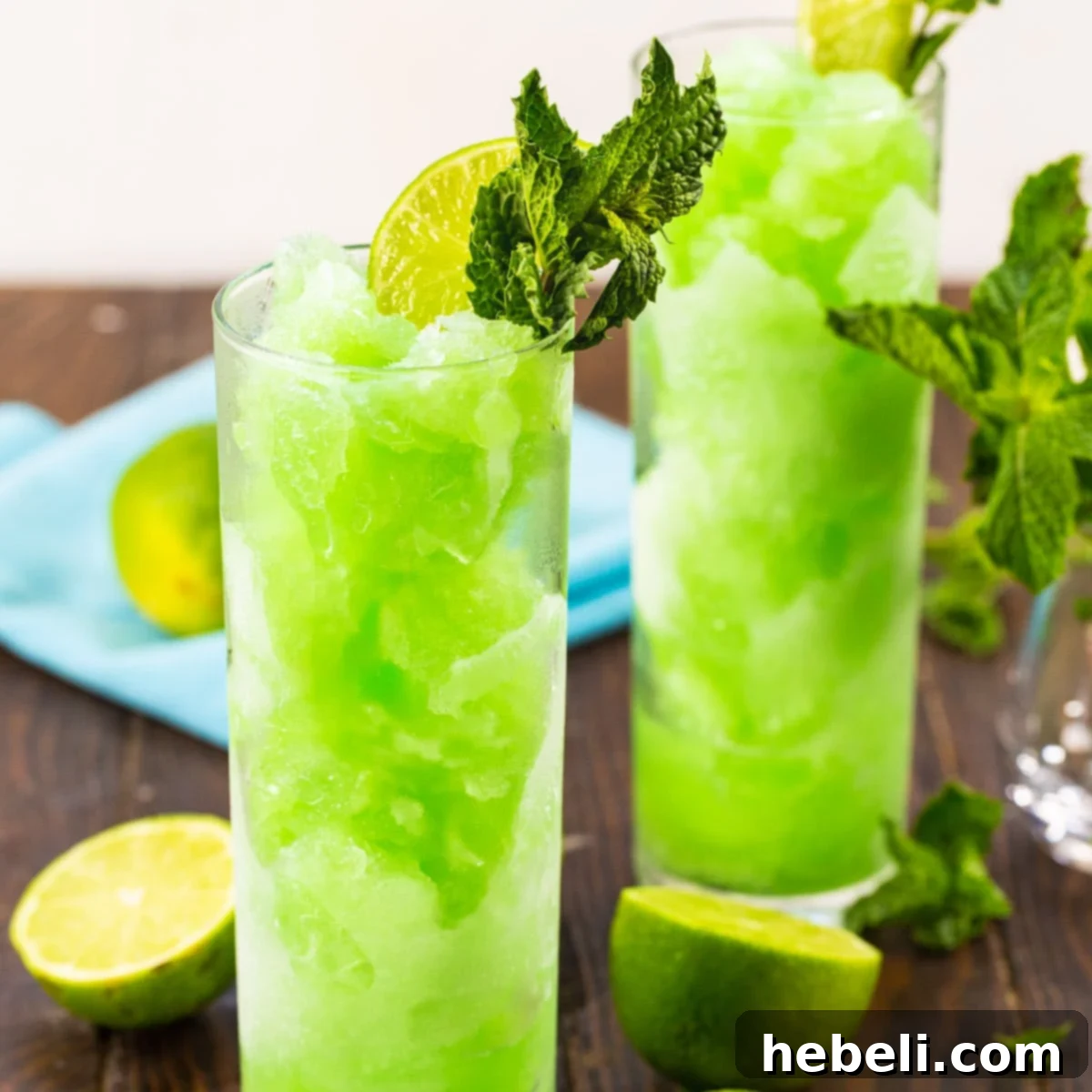 Mojito Slushies in tall glasses with fresh mint.