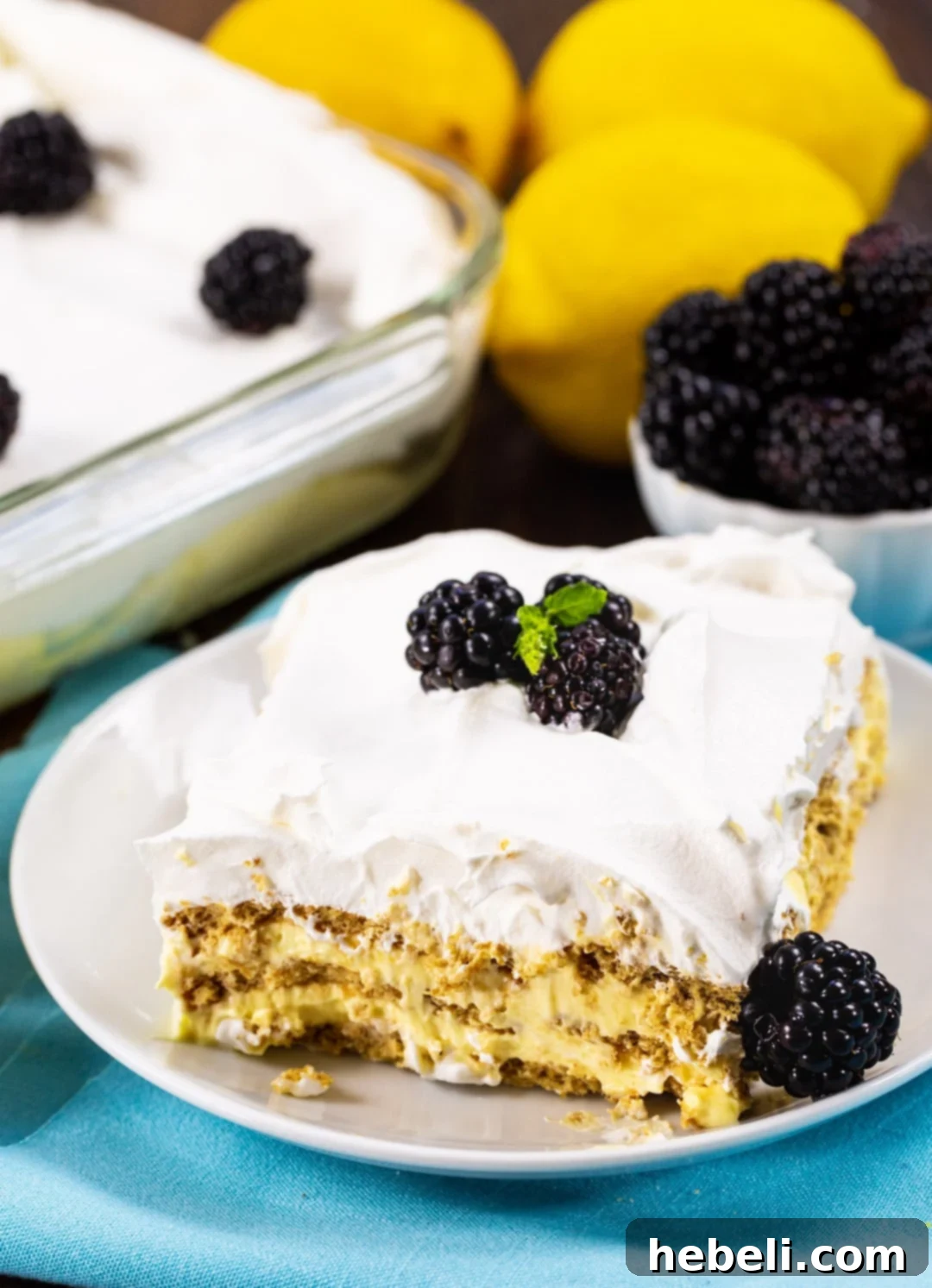 Zesty Lemon Icebox Cake 4 A perfectly portioned piece of Lemon Icebox Cake on a small white plate, ready to be enjoyed.