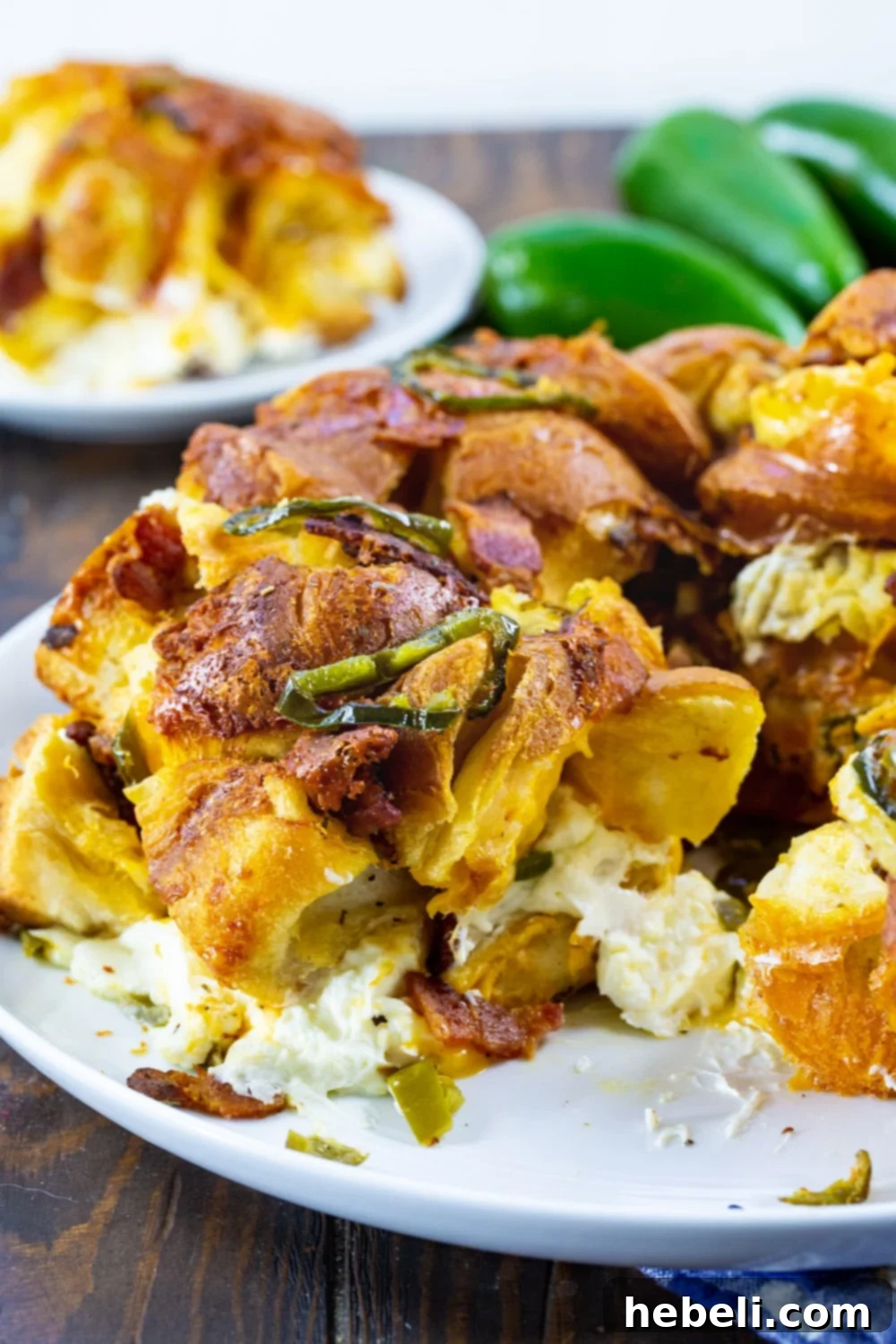 Gooey Jalapeno Cheese Bombs 7 Jalapeno Popper Monkey Bread with a piece removed to show the melted cream cheese in the middle.