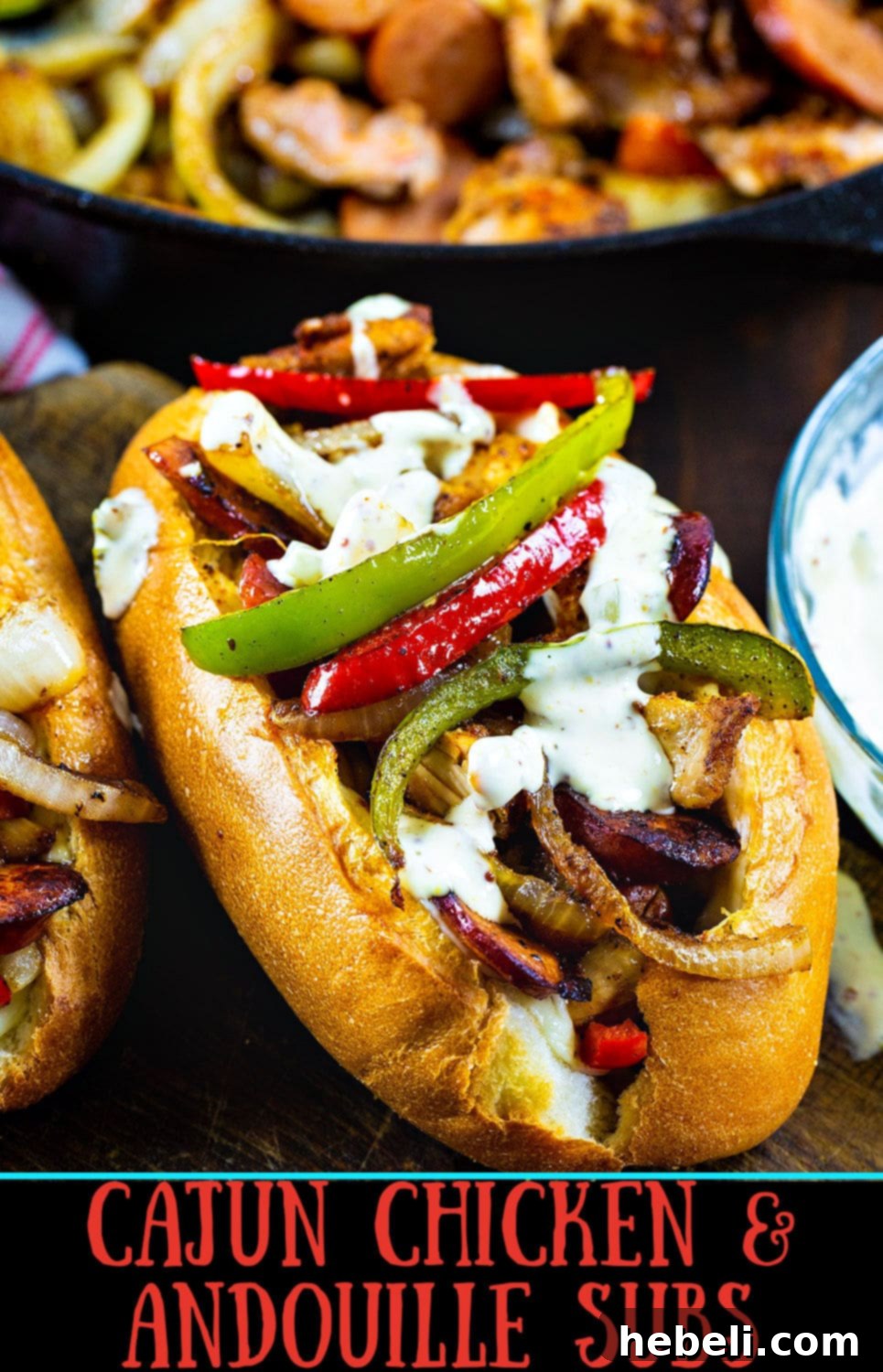 Close-up of a finished Cajun Chicken and Andouille Sub, highlighting the perfectly cooked chicken, spicy sausage, colorful peppers, onions, and melted provolone cheese, drizzled with zesty Cajun sauce.