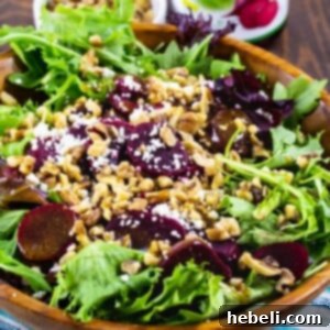 Pickled Beets Salad with Walnuts and Feta in a wooden bowl.