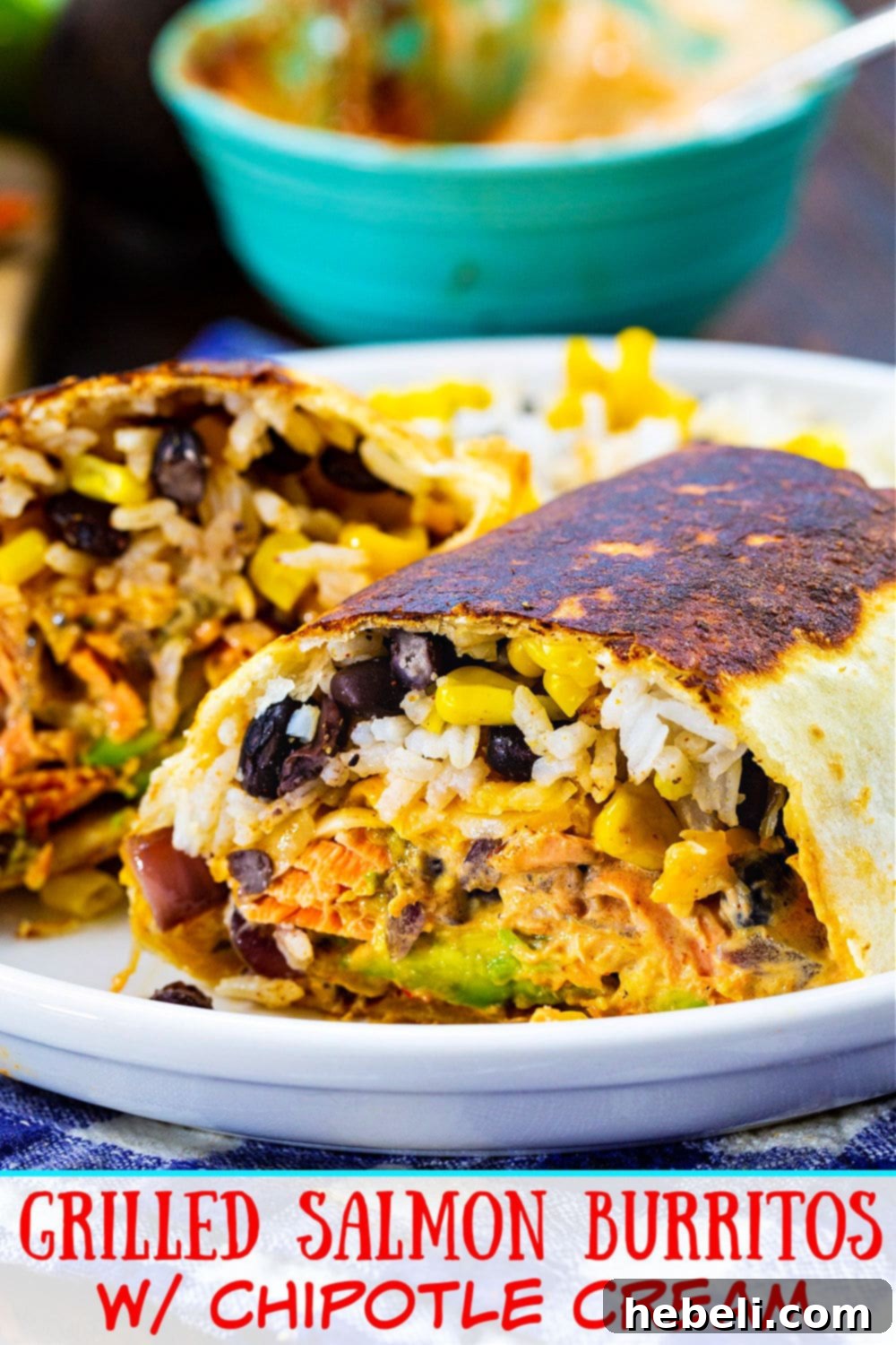 A golden-brown Grilled Salmon Burrito with Chipotle Cream, garnished and served on a rustic plate.
