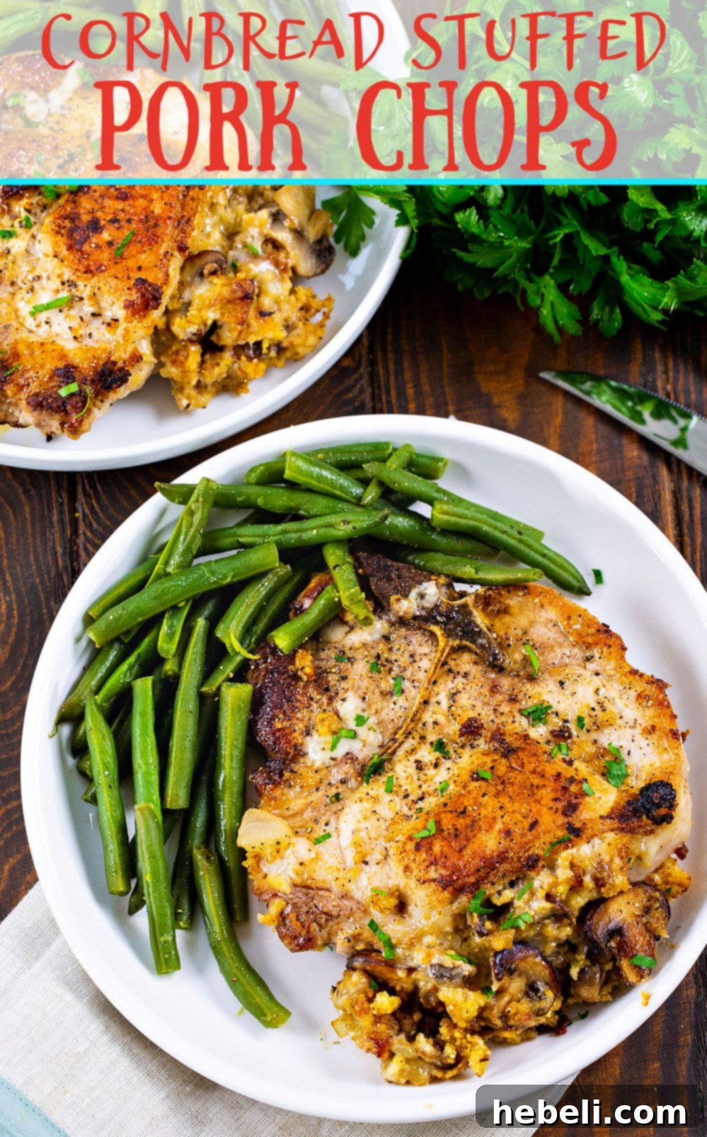 Close-up of a Cornbread Stuffed Pork Chop with mushrooms and melted white cheddar cheese, garnished with fresh herbs.
