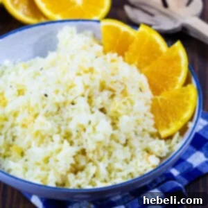 Orange Rice in a blue bowl with orange segments around edge.