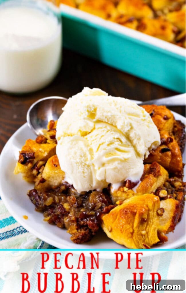 Pecan Pie Bubble Up dished up on a white plate with a scoop of vanilla ice cream, ready to be enjoyed.