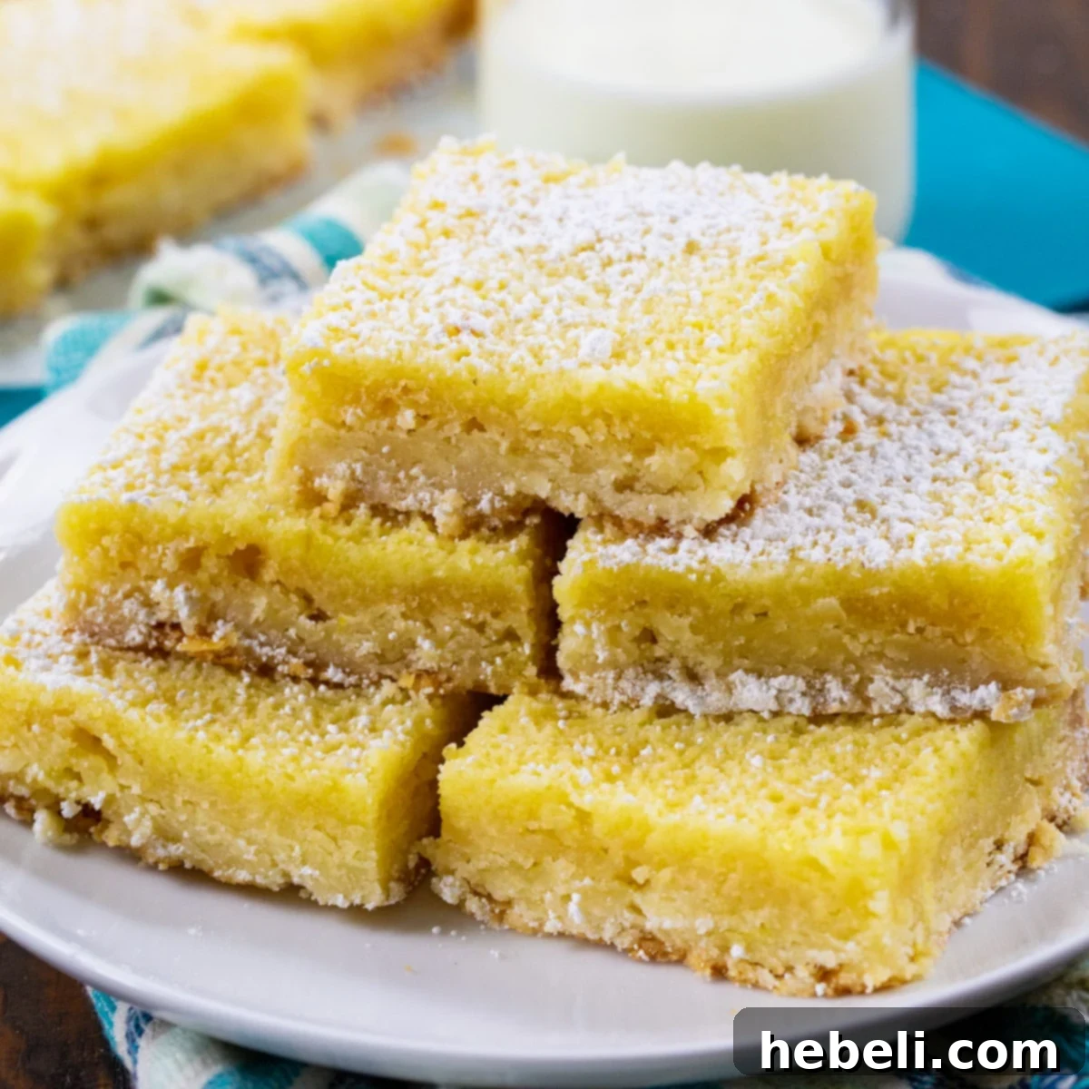 Buttermilk Chess Bars stacked on a plate.