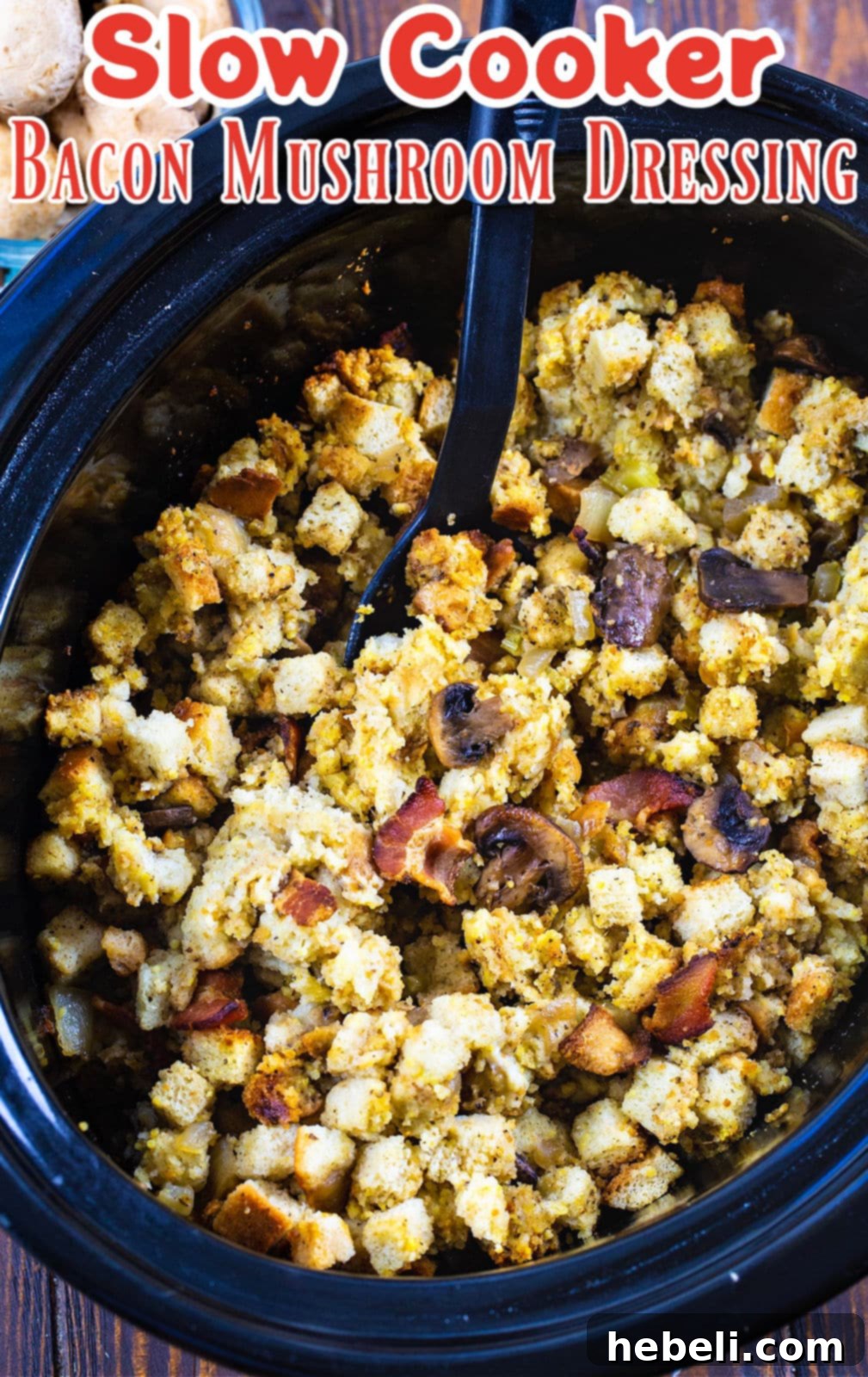 Savory Slow Cooker Bacon Mushroom Dressing 4 A serving of Slow Cooker Bacon Mushroom Dressing with a spoon, showing its moist texture.
