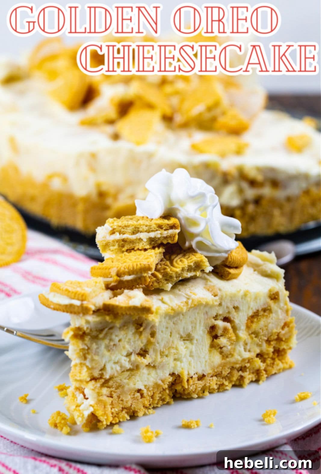 A close-up shot of a single slice of No-Bake Golden Oreo Cheesecake, highlighting the layers of golden crust, creamy filling, and cookie pieces.