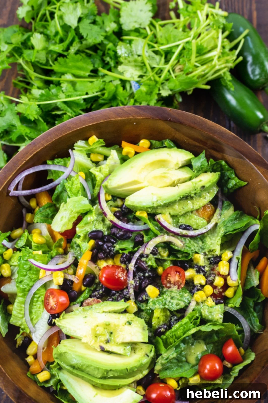 Close-up of Southwestern Salad in a wooden bowl, highlighting the colorful ingredients.