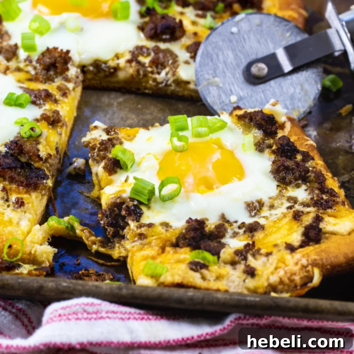 Breakfast Crescent Pizza with a slice cut.