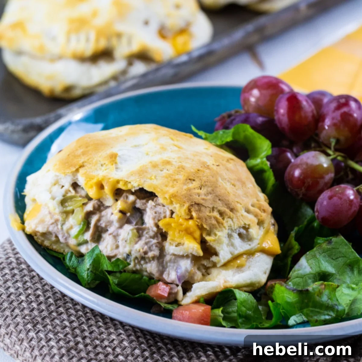 Freshly baked Biscuit Tuna Melts on a plate, ready to be served.