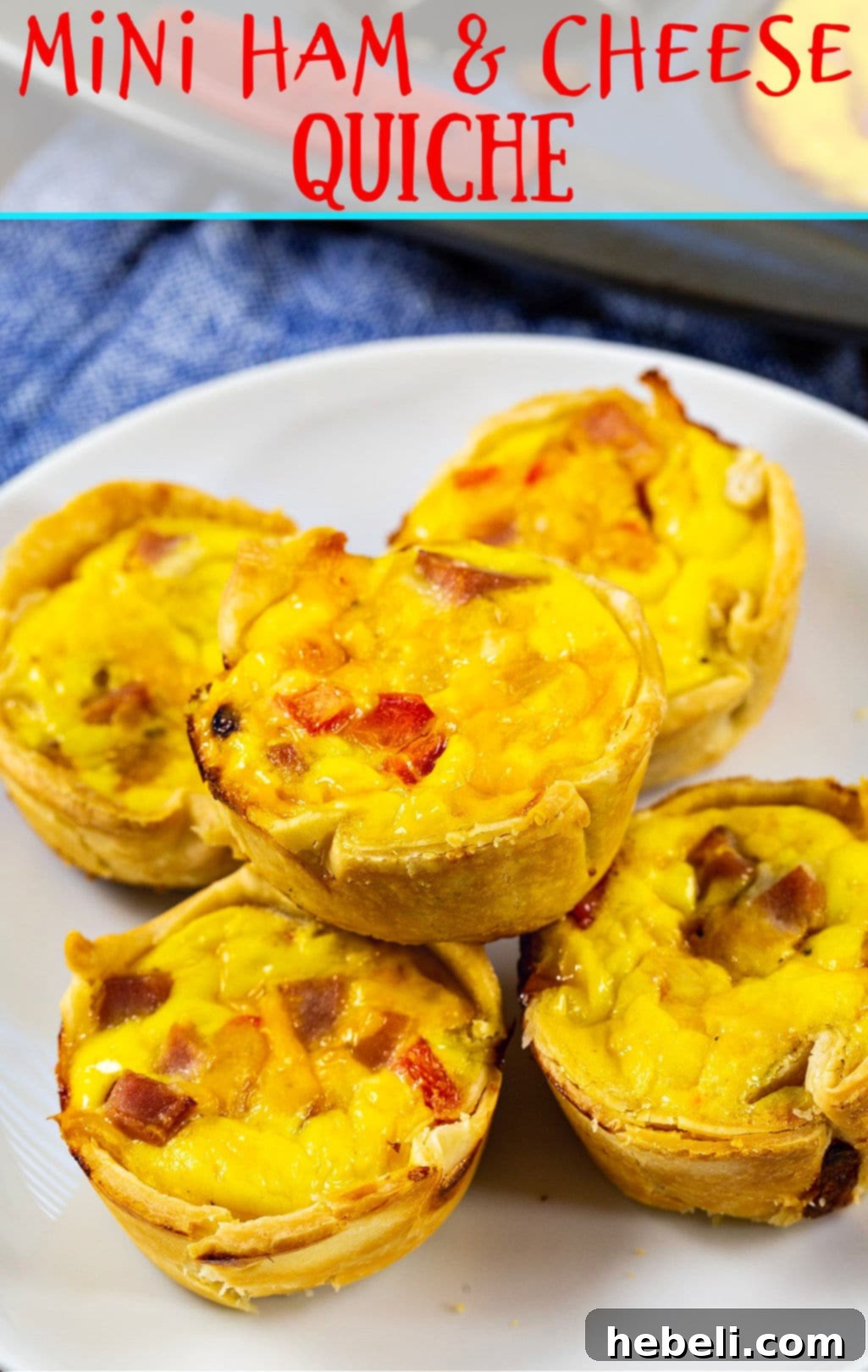 A stack of perfectly baked Mini Ham and Cheese Quiche, showcasing their golden-brown tops and savory filling.