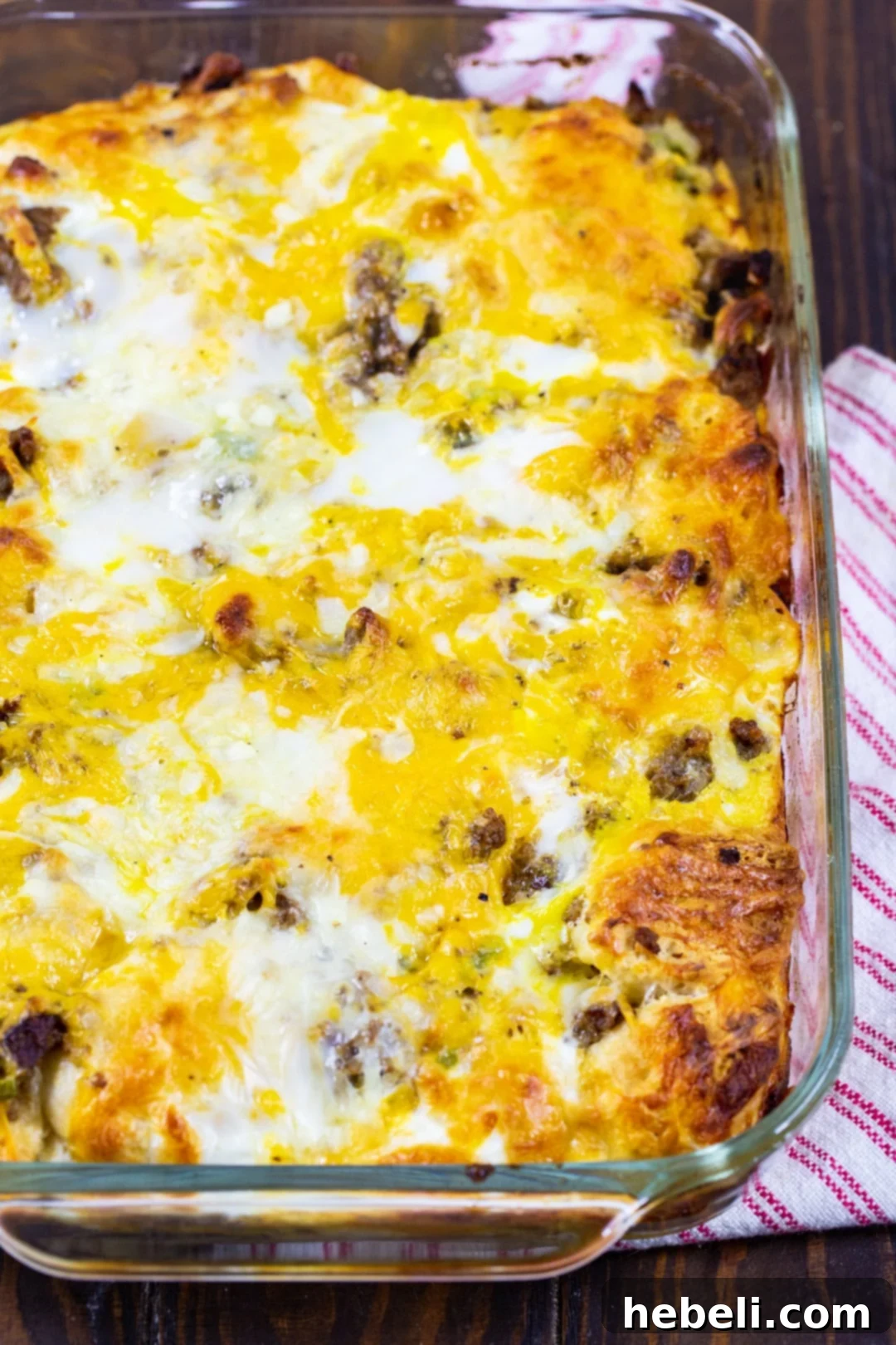 A large 9x13-inch baking dish filled with the golden-brown, bubbly Breakfast Biscuit Bubble Up Casserole, fresh out of the oven.