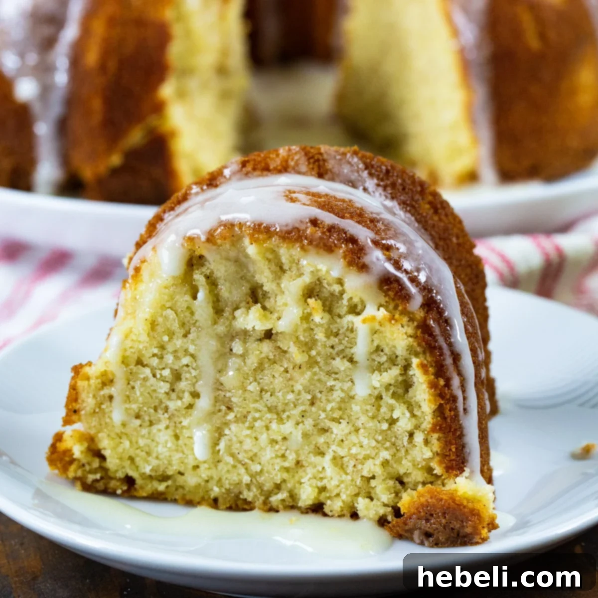 Holiday Eggnog Pound Cake 2 A beautifully sliced Eggnog Pound Cake on a plate, showcasing its moist texture and rich glaze, ready to be enjoyed.