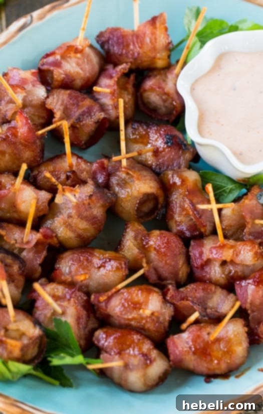 Close-up of golden-brown Bacon Wrapped Water Chestnuts, skewered with toothpicks and ready to serve.