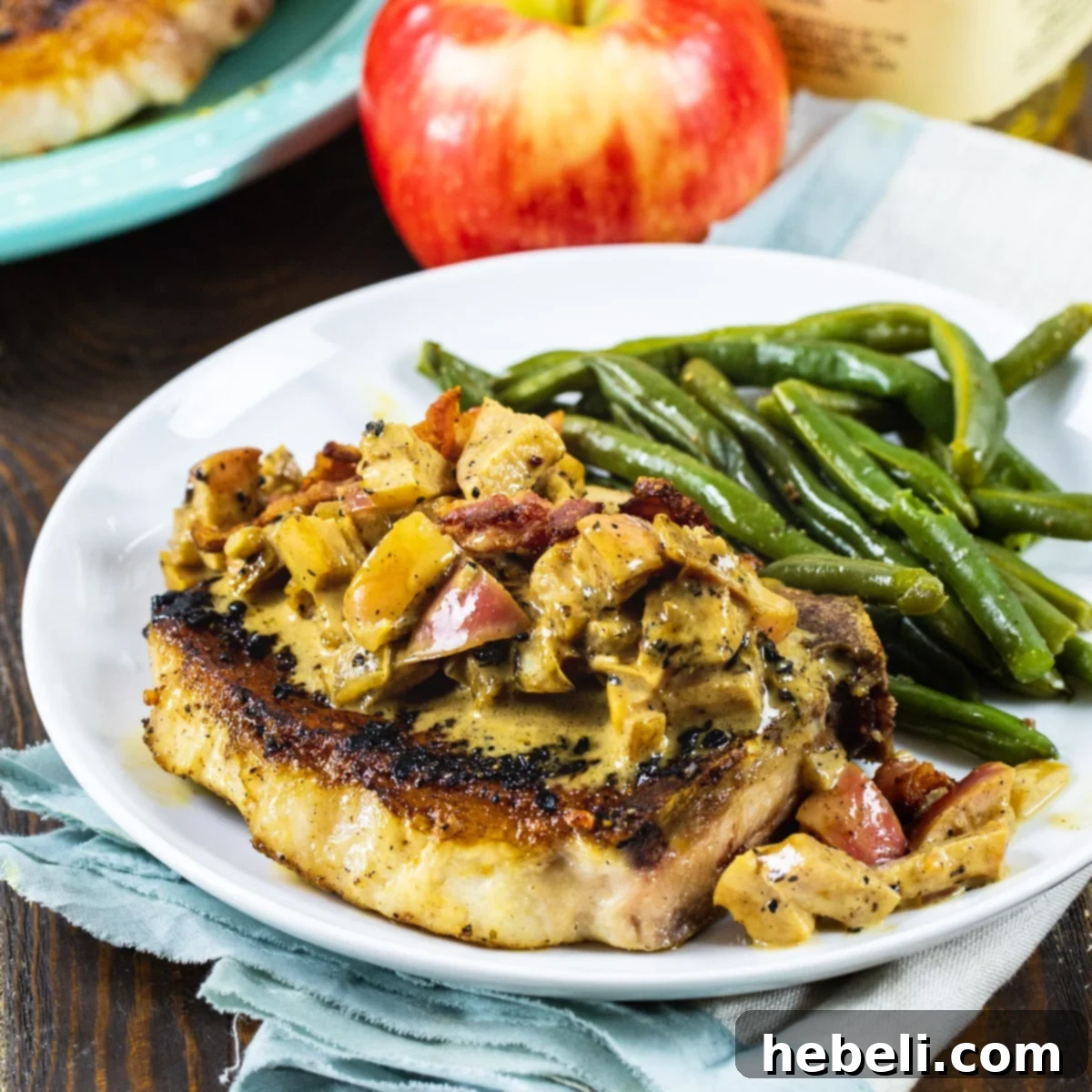 Bourbon Apple Pork Chops on plate with green beans.