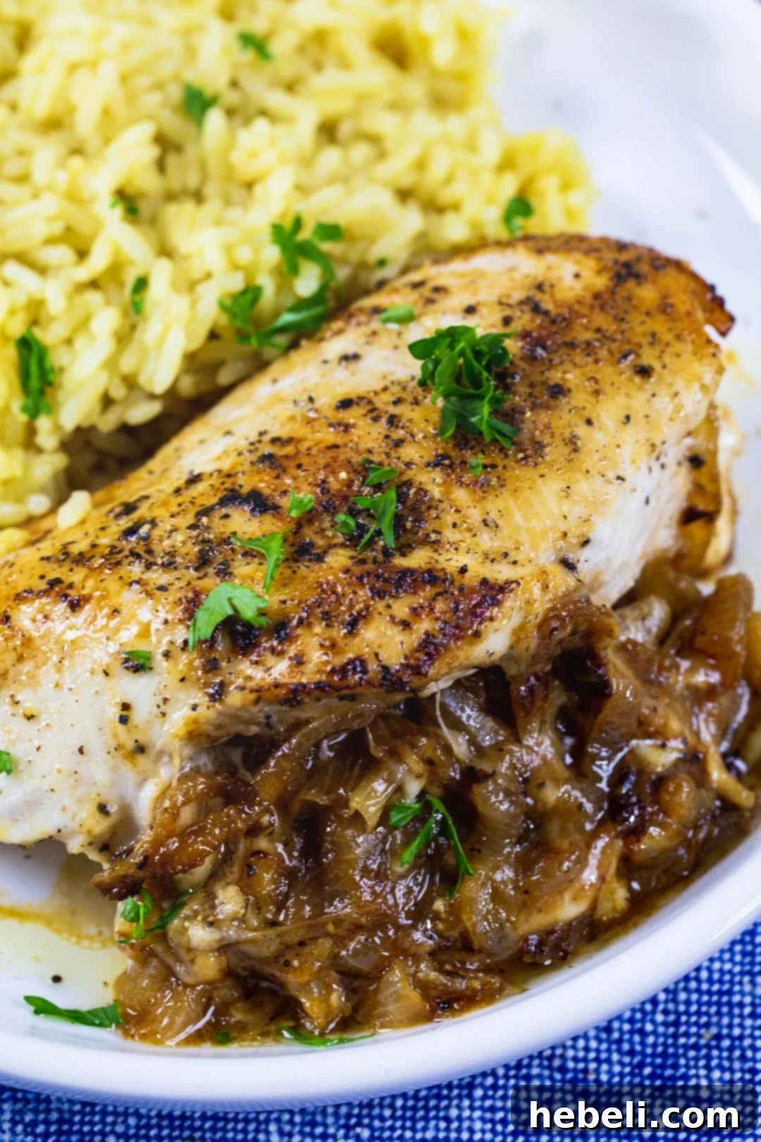 Stuffed Chicken Breast on plate with yellow rice.