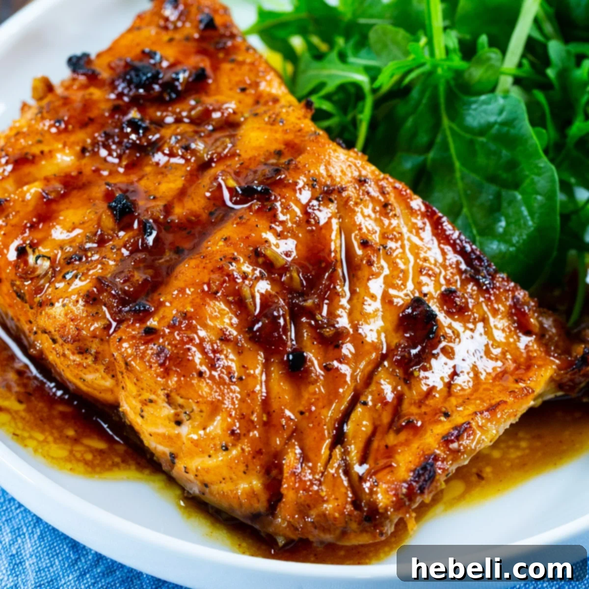 Perfect Honey Garlic Salmon 2 Honey Garlic Salmon on plate with green salad.