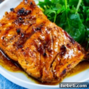 Honey Garlic Salmon on plate with green salad.