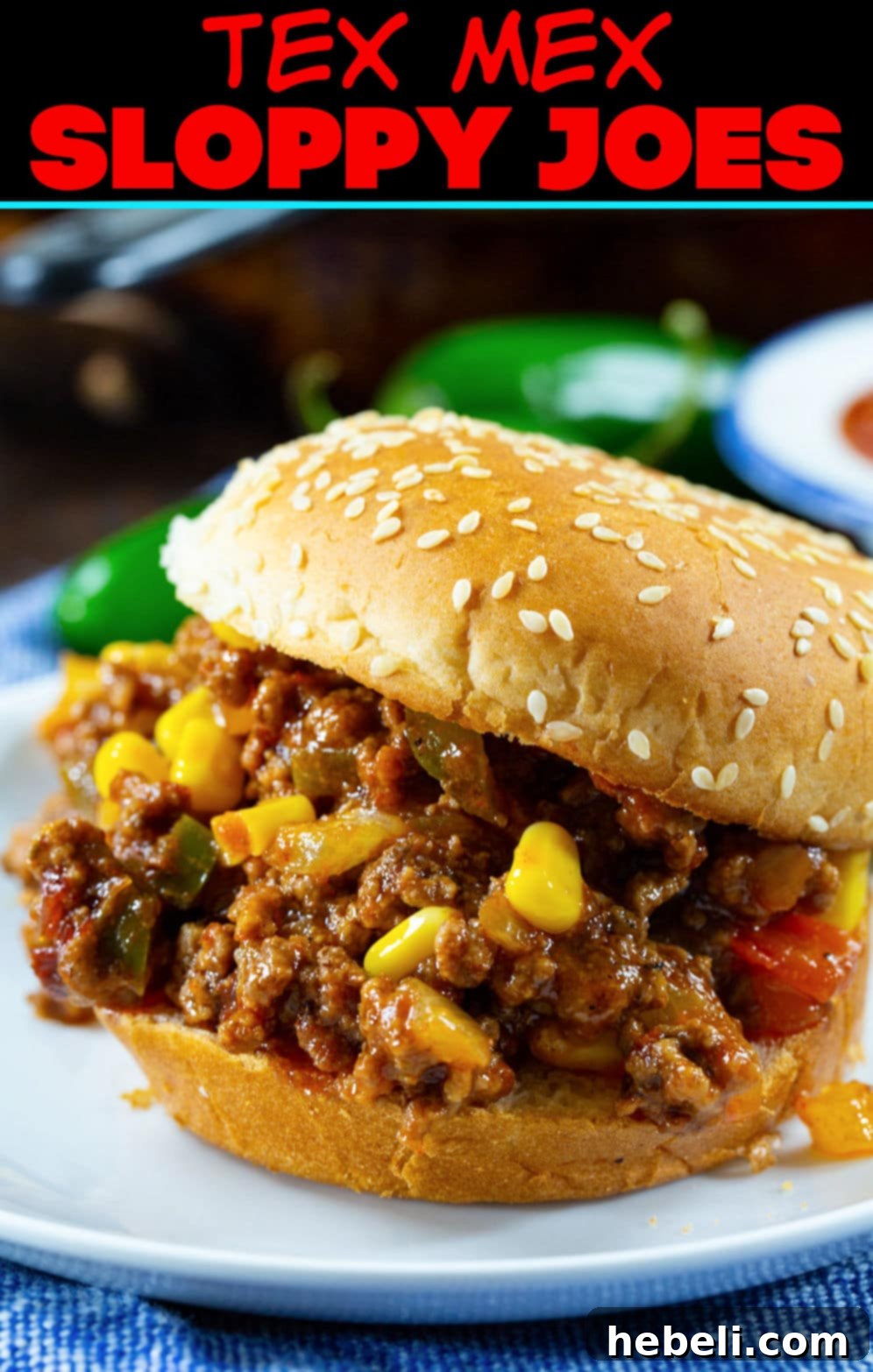 Close-up of a Tex-Mex Sloppy Joe on a bun, showcasing the rich, savory filling with visible peppers and corn.
