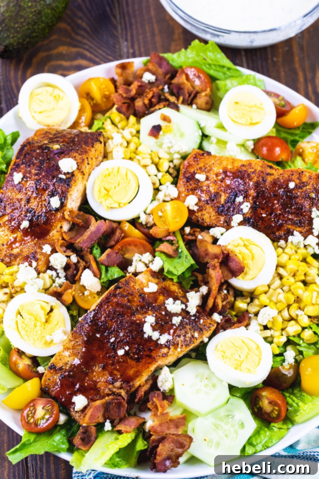 Smoky BBQ Salmon Cobb Salad 3 Close-up view of a perfectly cooked and caramelized BBQ Salmon fillet, glistening with sauce, ready to be flaked onto the salad.