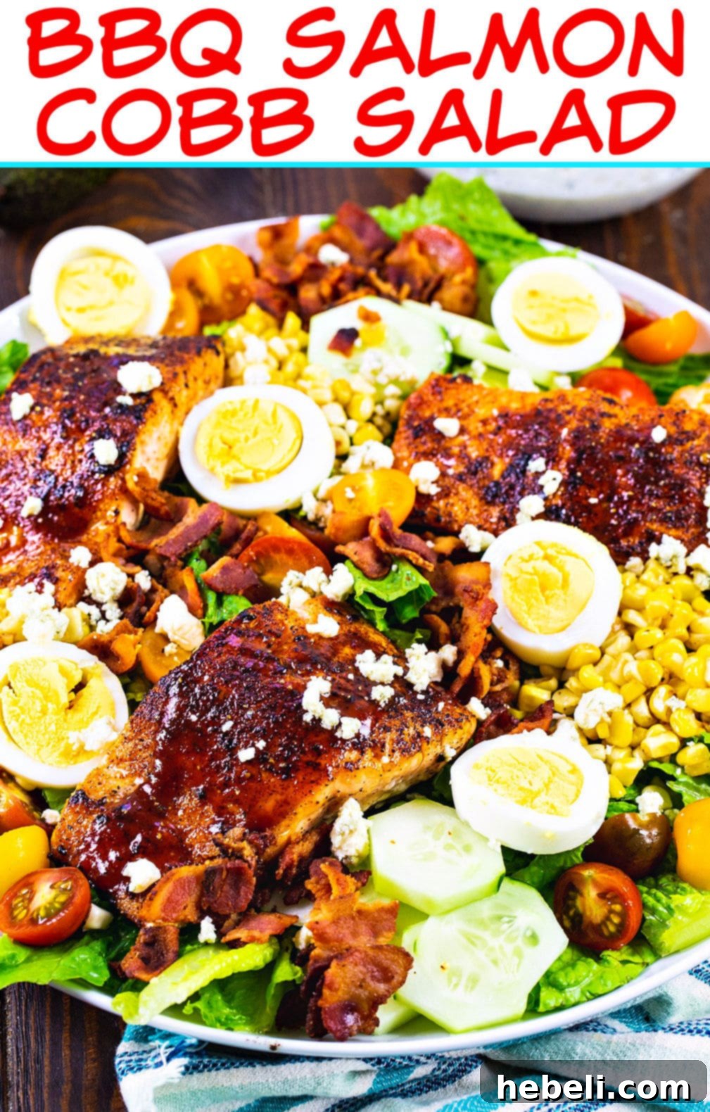 Smoky BBQ Salmon Cobb Salad 4 A vibrant, close-up shot of the BBQ Salmon Cobb Salad, showcasing the distinct layers of fresh ingredients and the perfectly cooked salmon, ready for a dressing drizzle.