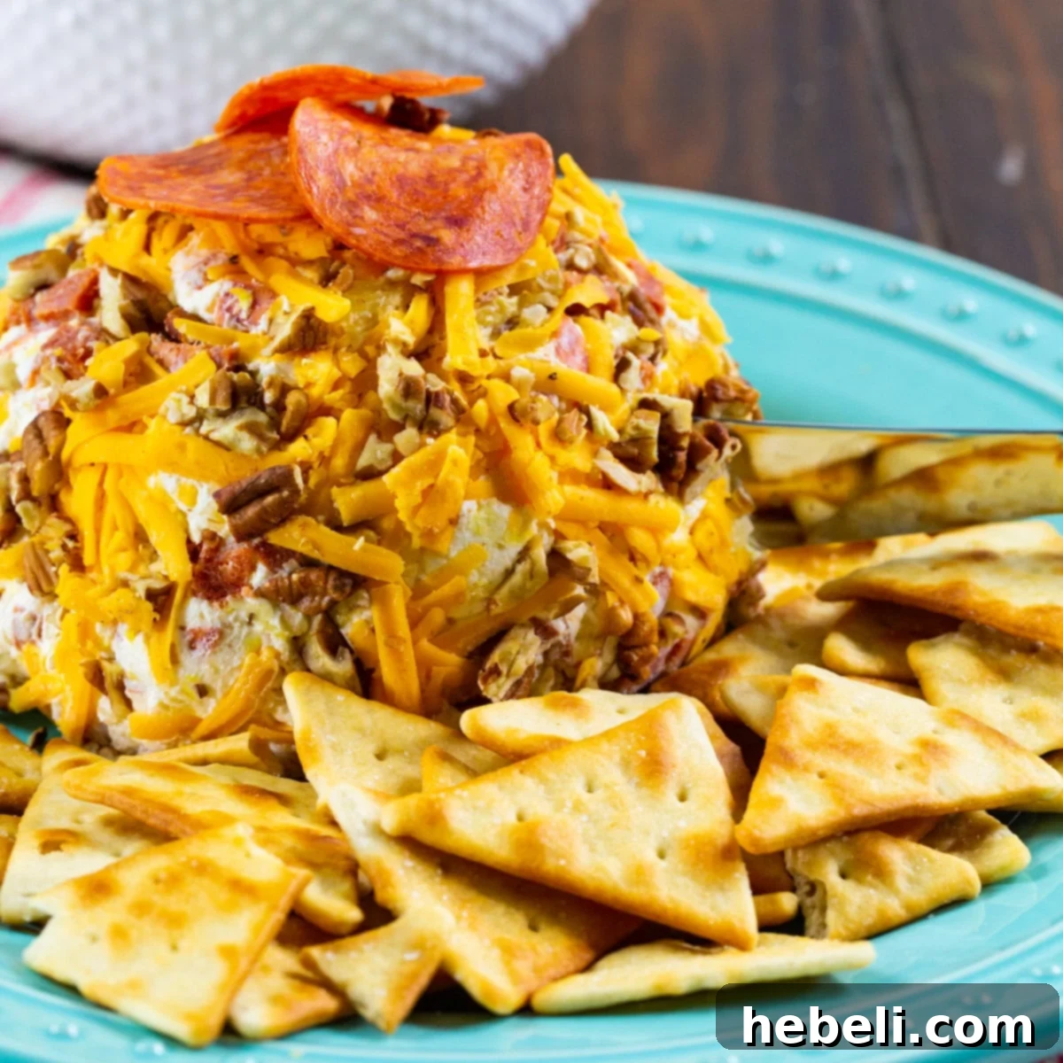 Loaded Pepperoni Cheese Ball 2 Pepperoni Cheese Ball on a serving plate with assorted crackers, ready for a party.