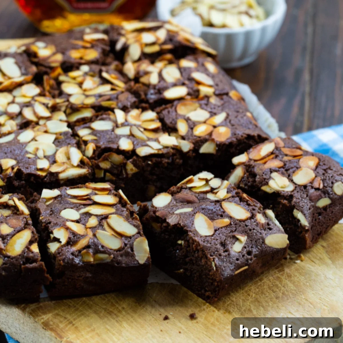 Decadent Amaretto Fudge Brownies 2 Amaretto Brownies cut into perfect squares, showcasing their fudgy interior and almond topping.
