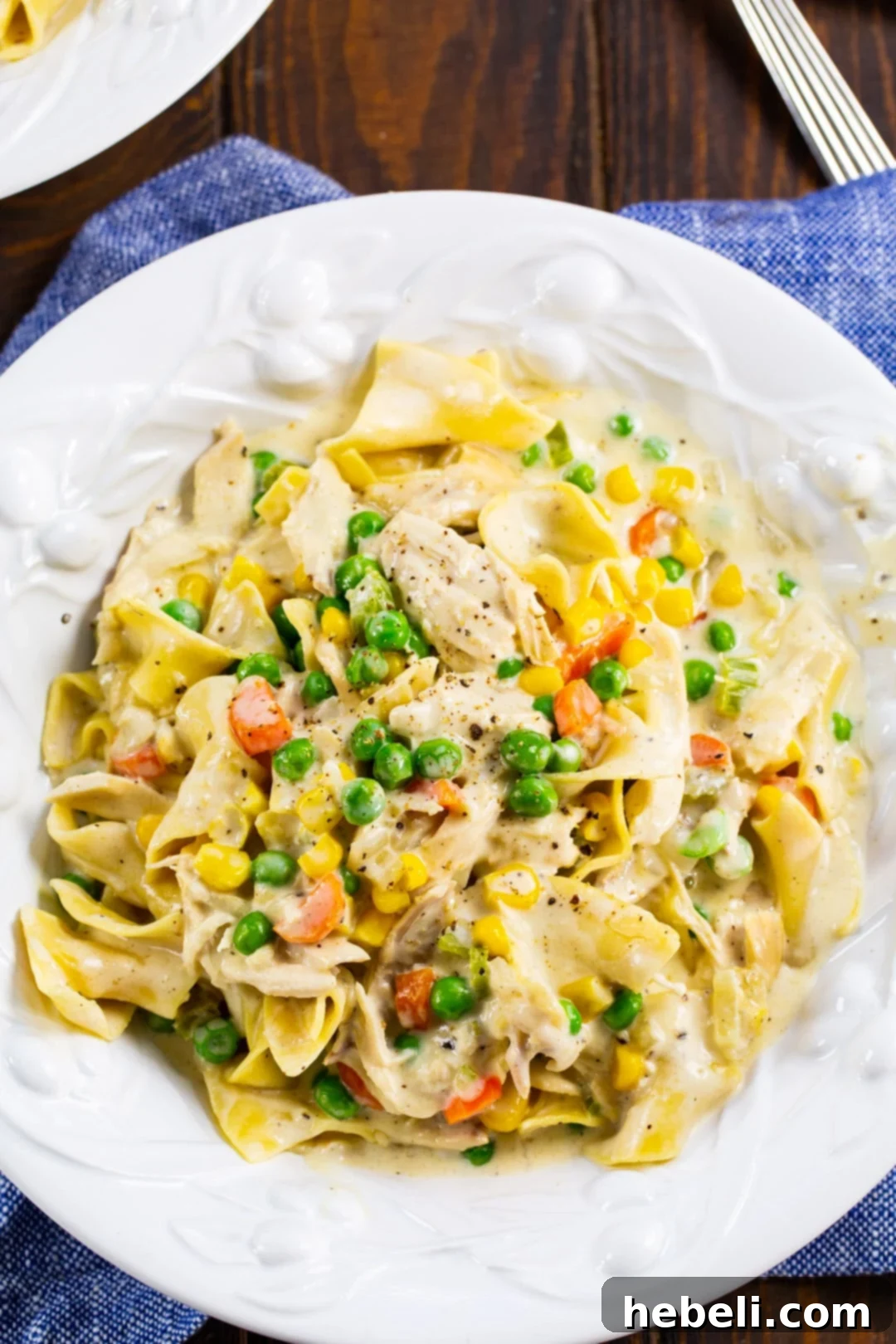 Pot Pie Noodle Casserole 3 Close-up of Chicken Pot Pie Noodles in a bowl, showing the rich sauce and diced vegetables.