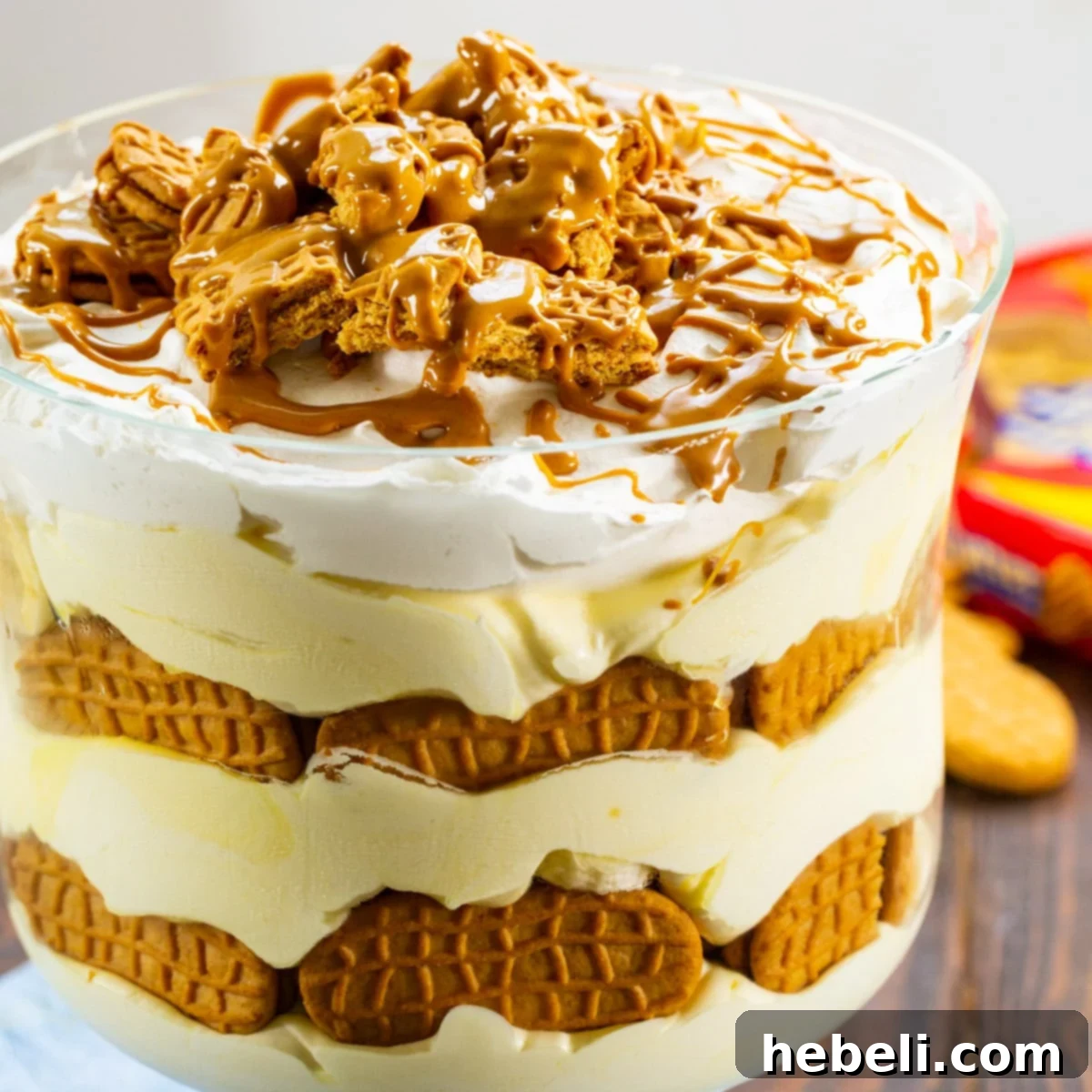Nutter Butter Banana Pudding 2 Decadent Nutter Butter Banana Pudding in a clear trifle dish, showcasing layers of creamy pudding, banana slices, and Nutter Butter cookies.