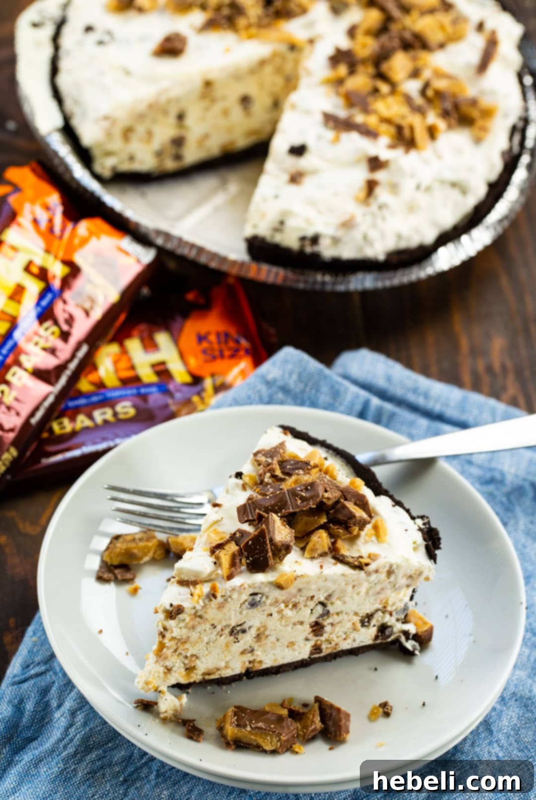 A beautifully presented whole Frozen Toffee Pie with a single slice removed, revealing the creamy interior and an inviting texture.