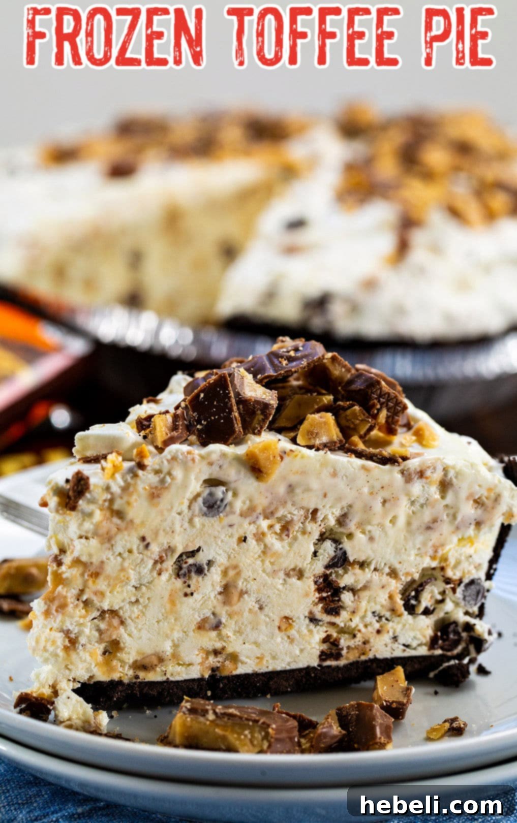 Another mouth-watering view of a delicious slice of Frozen Toffee Pie, showcasing its perfectly set layers and abundant chopped Heath bar topping.