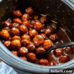 Sweet and Spicy Grape Meatballs 5 Spicy Grape Meatballs in a slow cooker, ready to be served.
