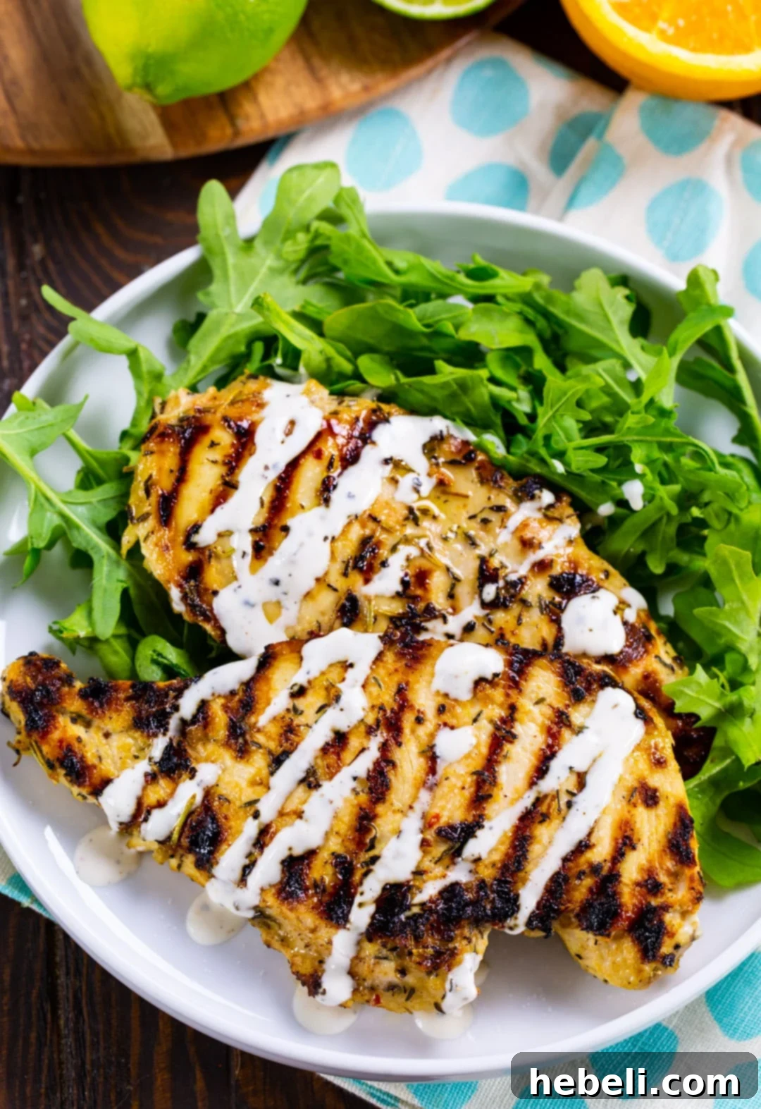 Sun-Kissed Grilled Chicken 3 Two perfectly grilled citrus chicken breasts on a plate with fresh arugula, ready to be served.