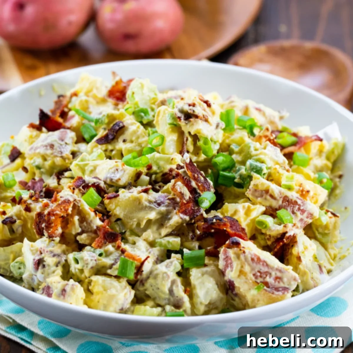 Honey Mustard Potato Salad in a serving bowl, garnished with fresh herbs.