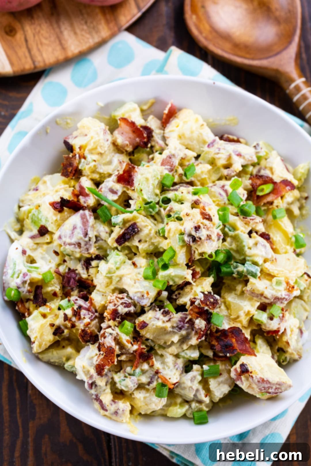 Close-up of Honey Mustard Potato Salad in a serving bowl, showcasing the creamy texture and bacon bits.