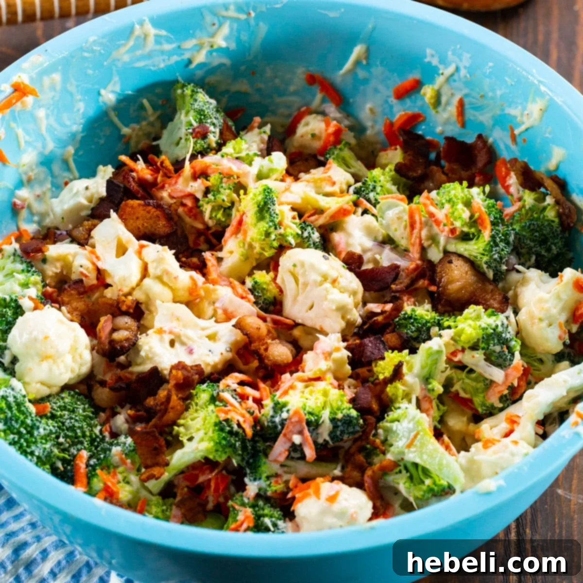 Zesty Marinated Broccoli and Cauliflower Salad 2 Freshly prepared Marinated Broccoli and Cauliflower Salad in a stylish blue bowl, ready to be served, highlighting its vibrant colors and textures.